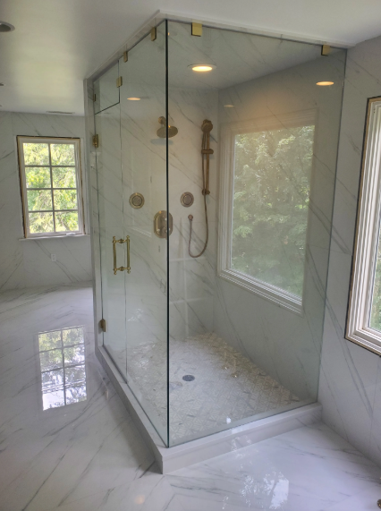 Bright white bathroom with a glass shower, tub, and stained-glass window over the sink.