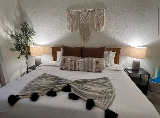 A bedroom with a  perfect and clean bed, that has been cleaned by Bunny's cleaning service in Coachella Valley, CA
