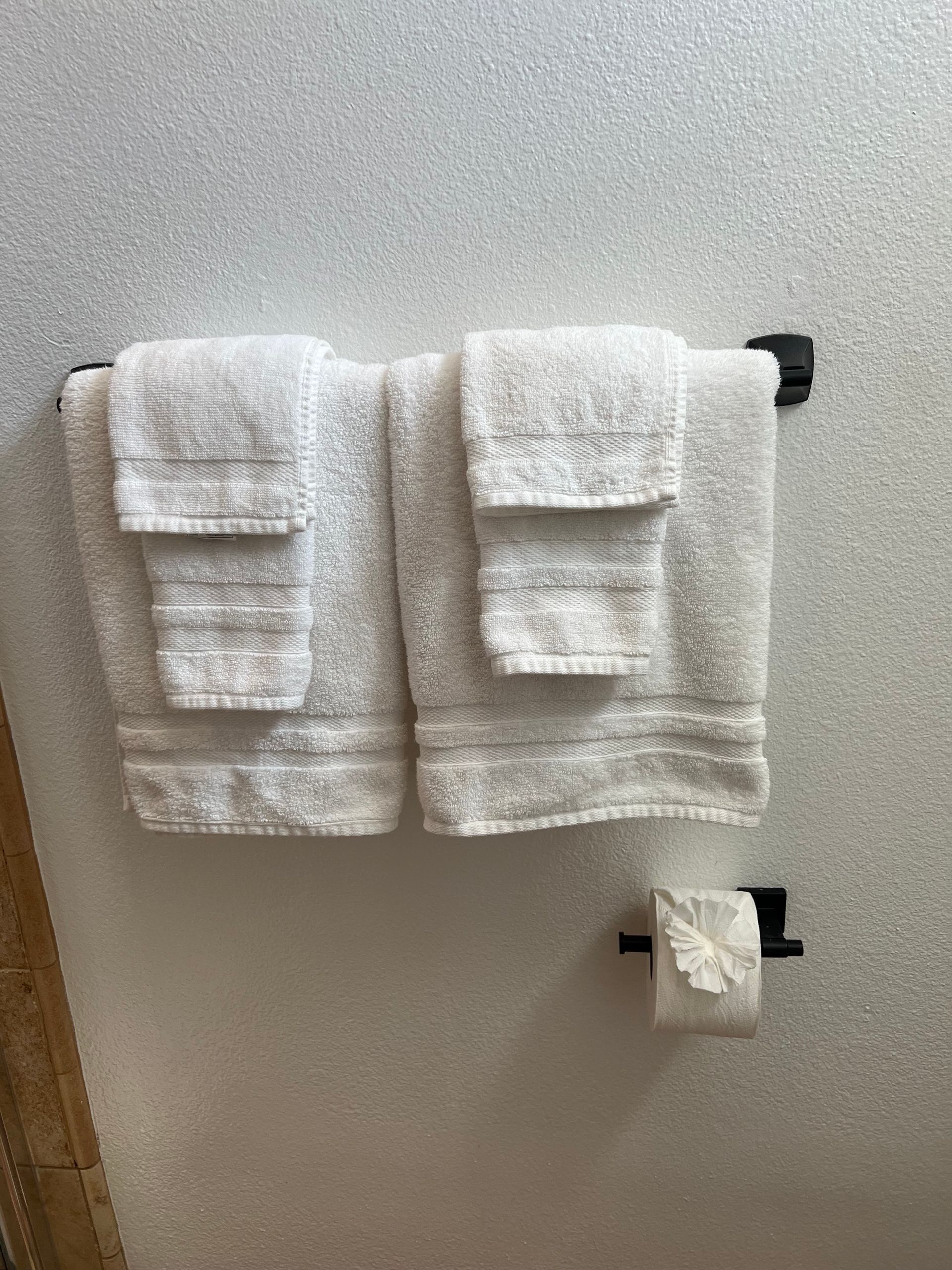 Image of neatly folded towels and toilet paper in a vacation rental property in Palm Desert. 