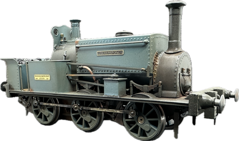 A model train with a smoke stack on top of it on a white background.