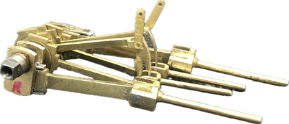 A close up of a brass object on a white background.