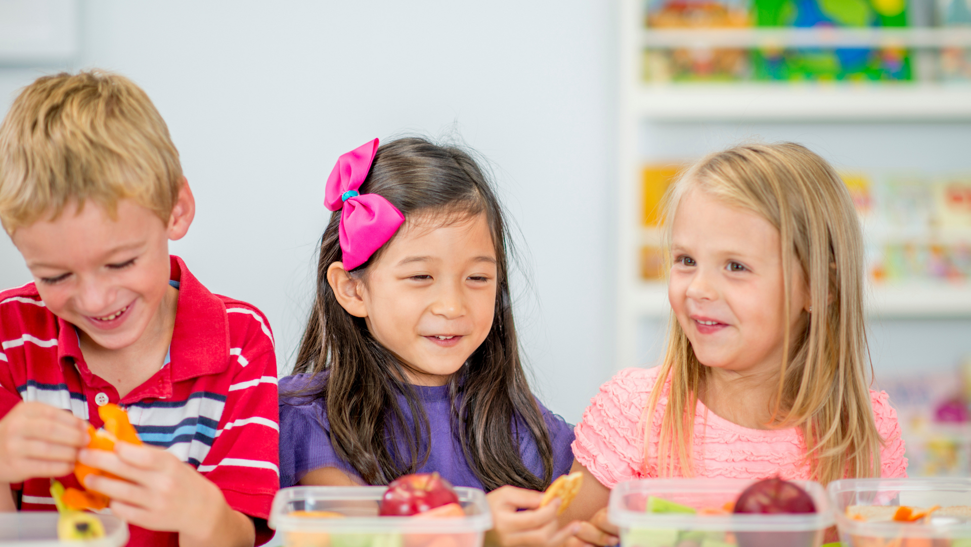 Kids eating healthy snacks and showing their healthy smile