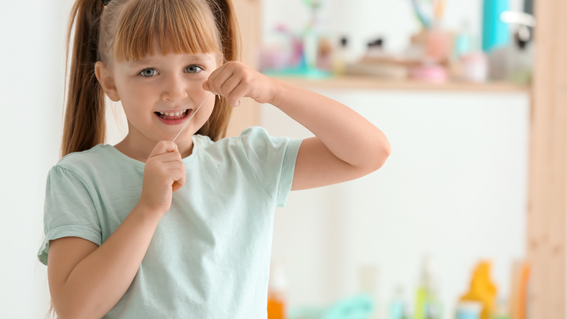 Kid flossing teeth