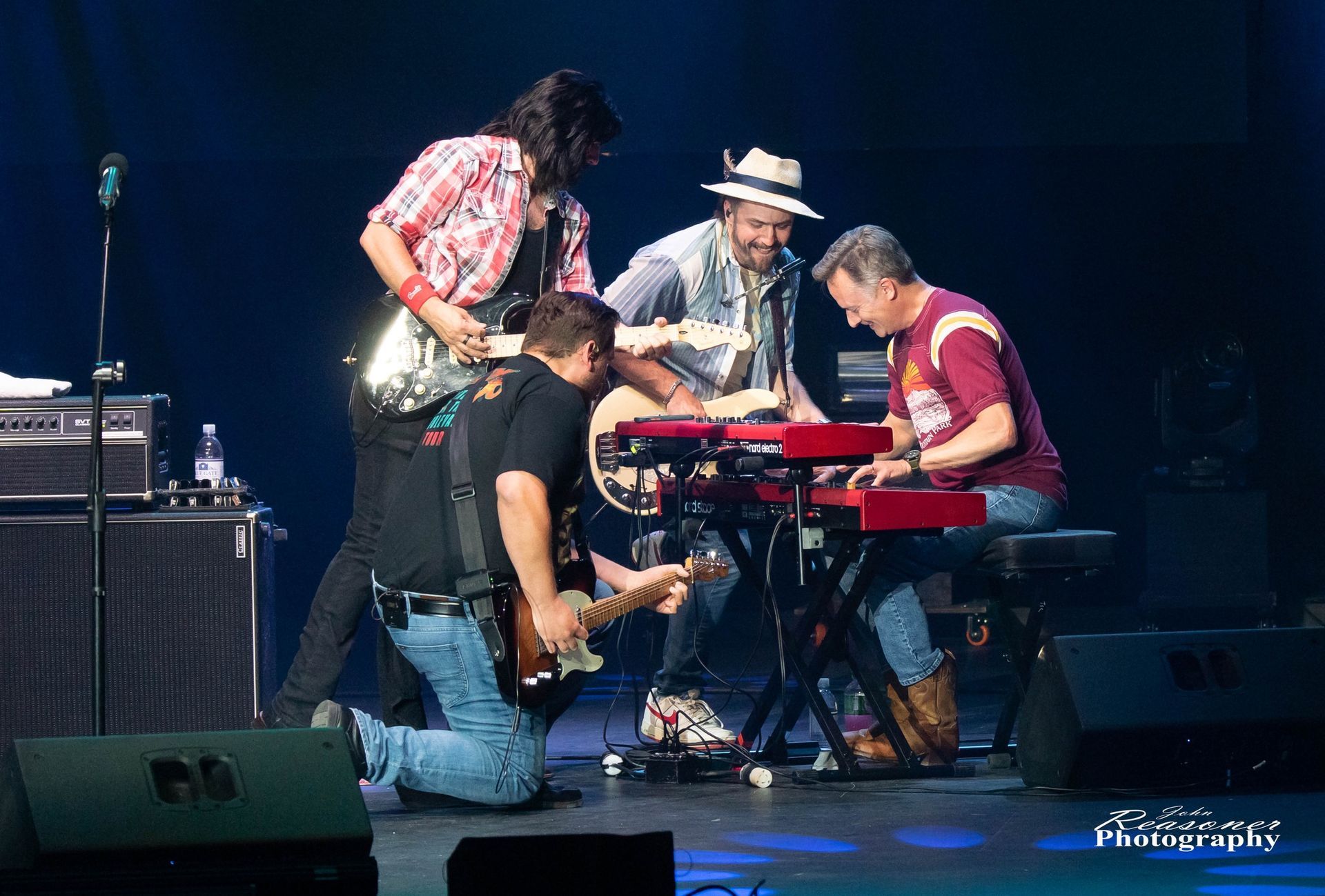 A group of men are playing musical instruments on a stage.