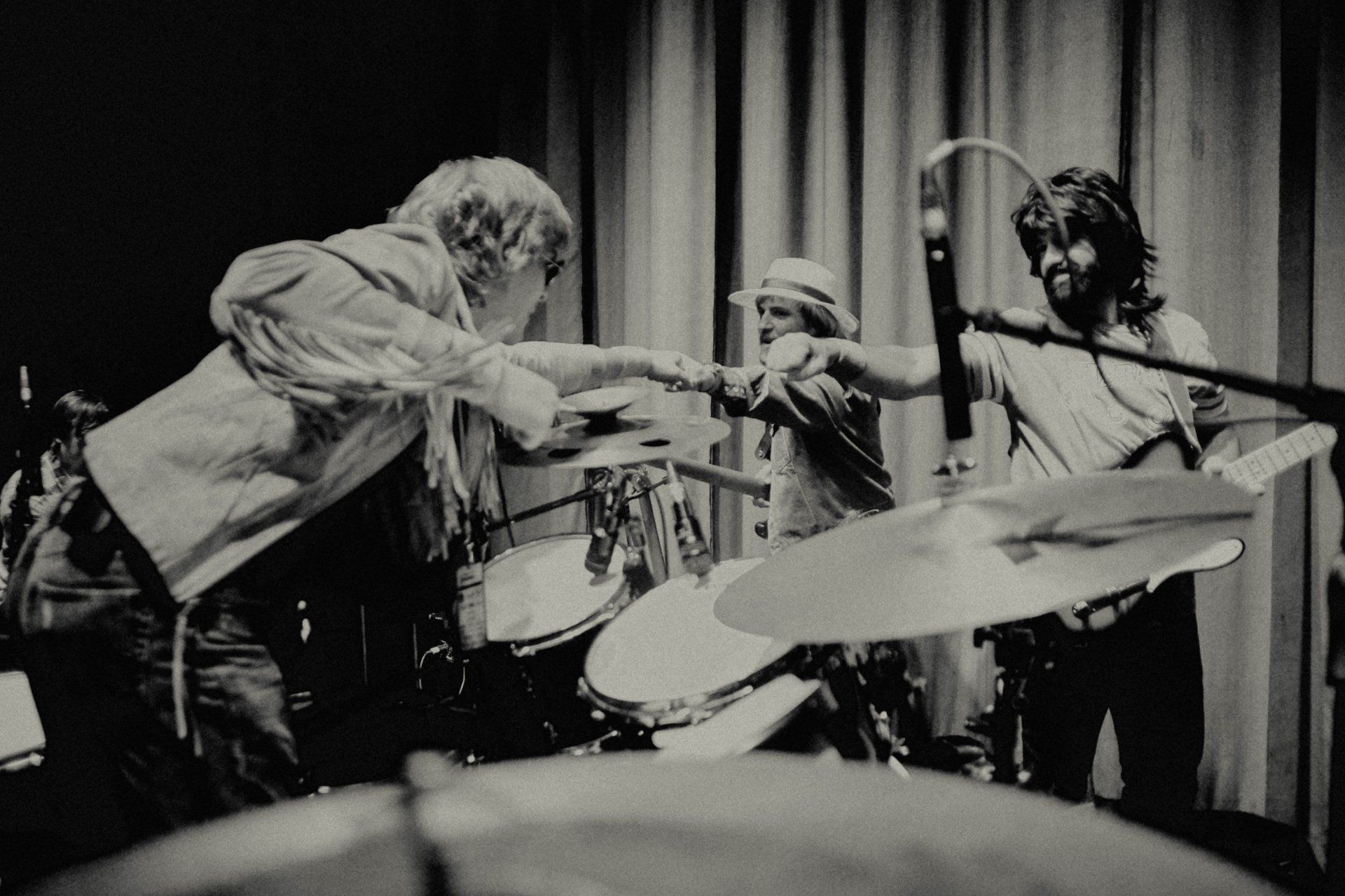 A black and white photo of a band playing drums
