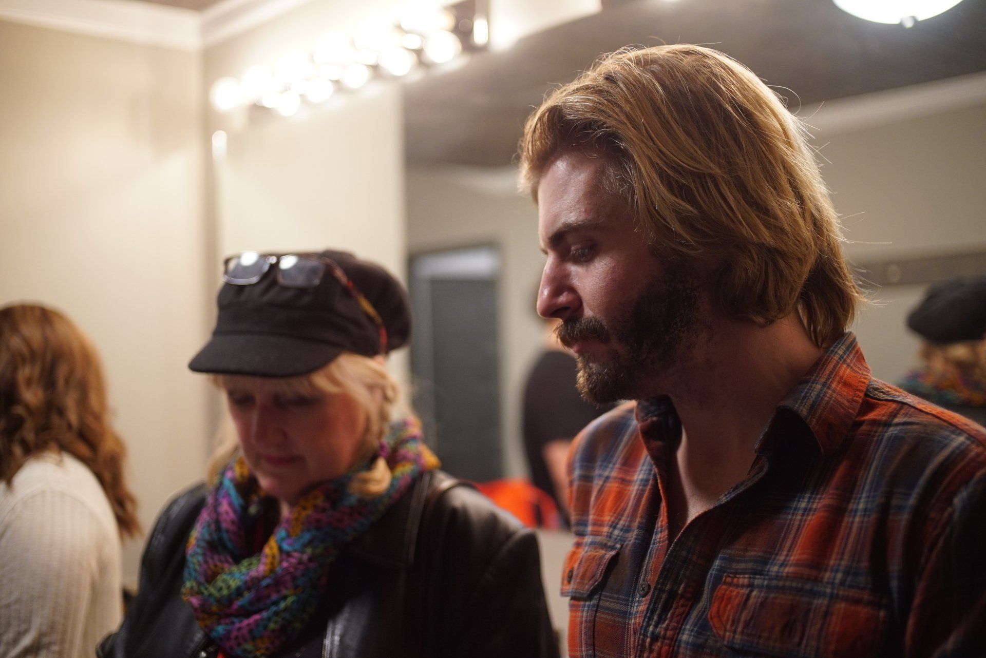 A man and a woman are standing next to each other in a room.