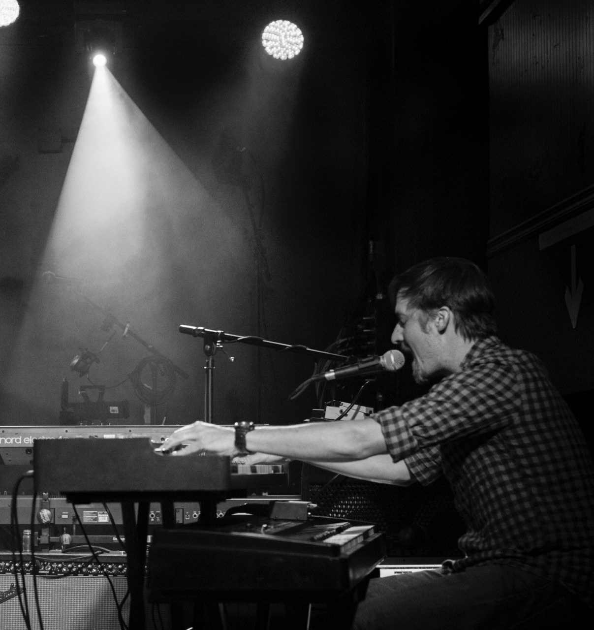 A black and white photo of a man playing a keyboard