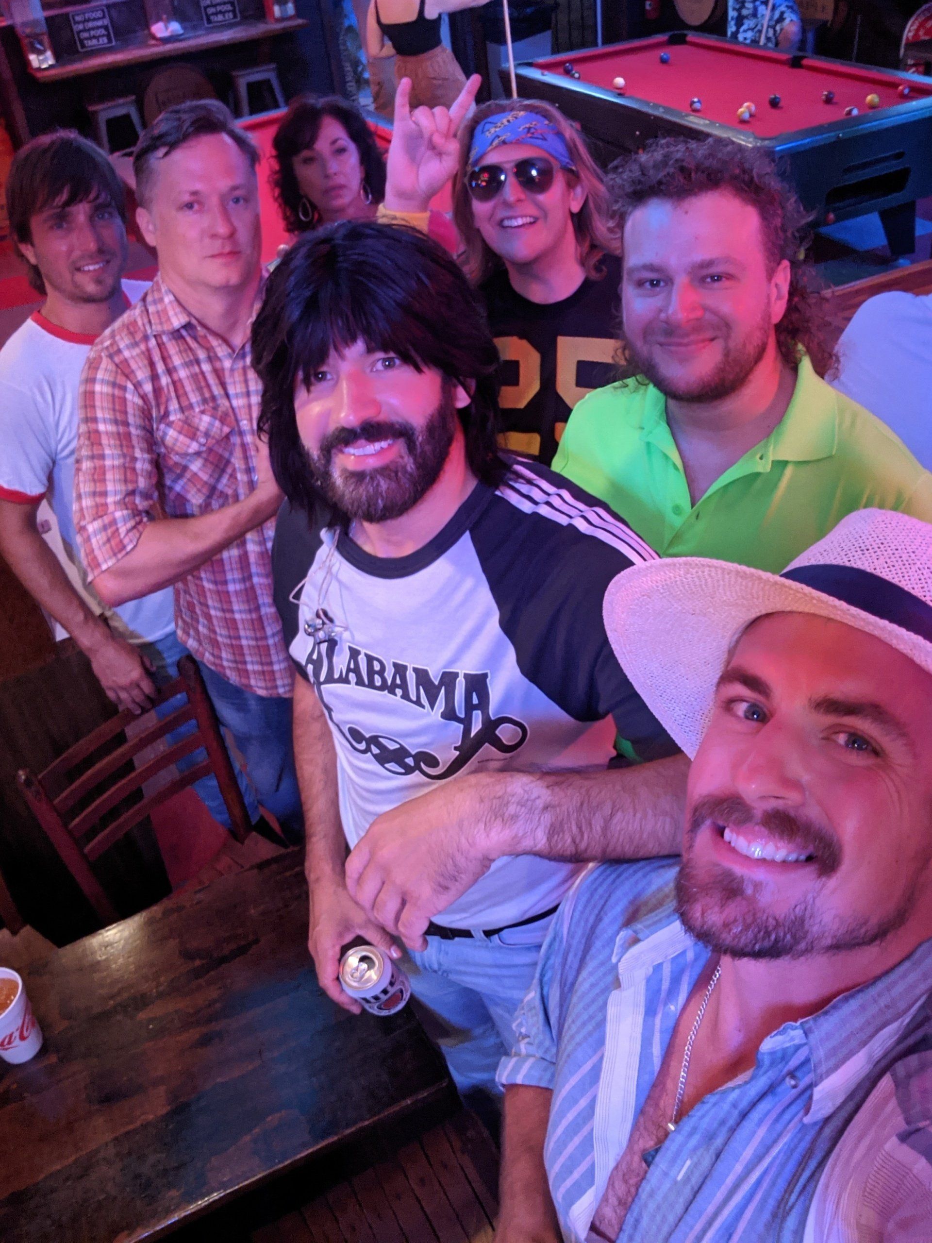 A group of people posing for a picture with one man wearing an alabama shirt
