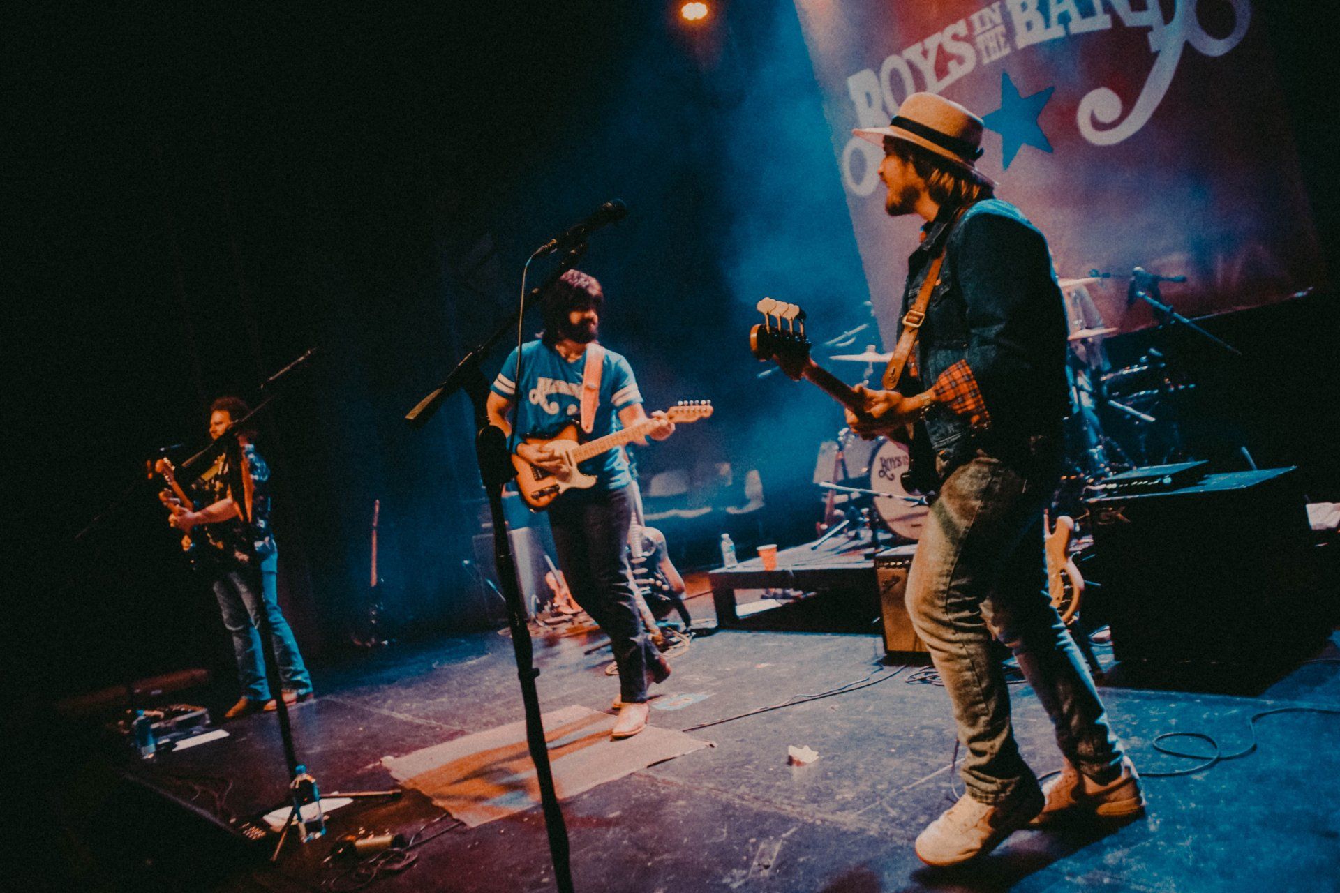 A group of men are playing guitars on a stage.