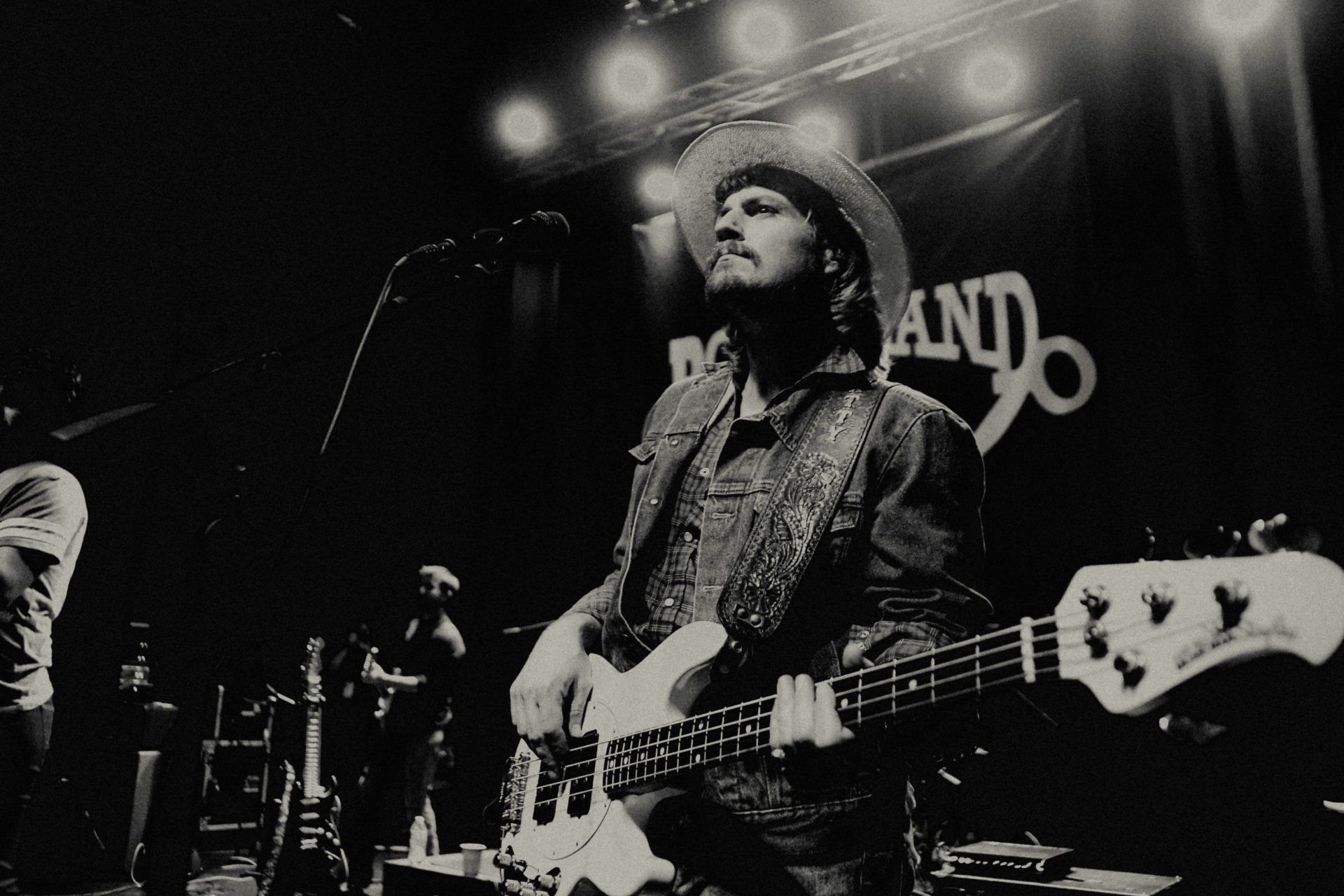 A black and white photo of a man playing a guitar