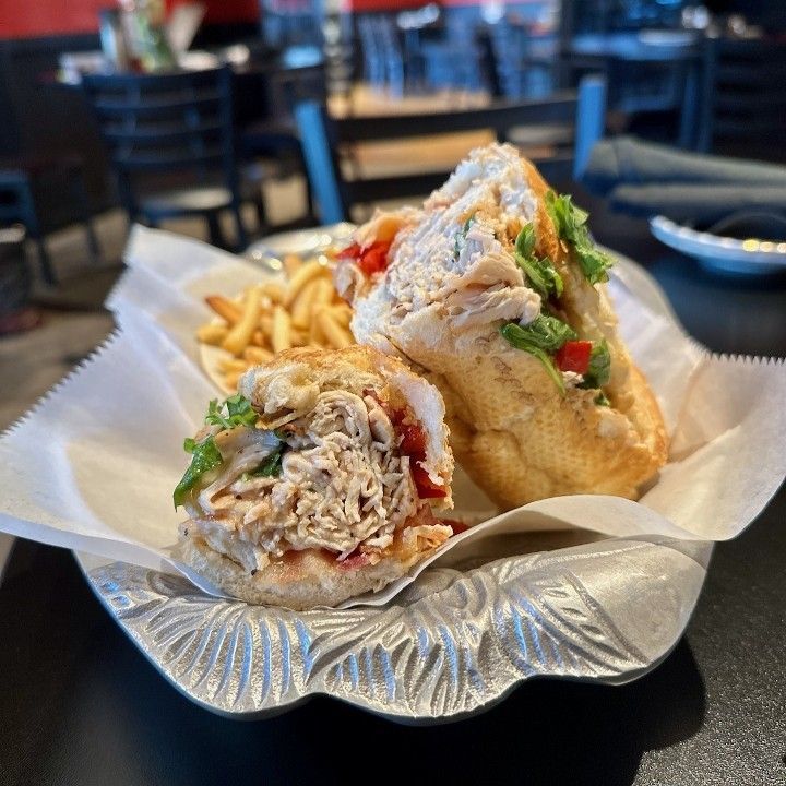 a sandwich and french fries are on a plate on a table
