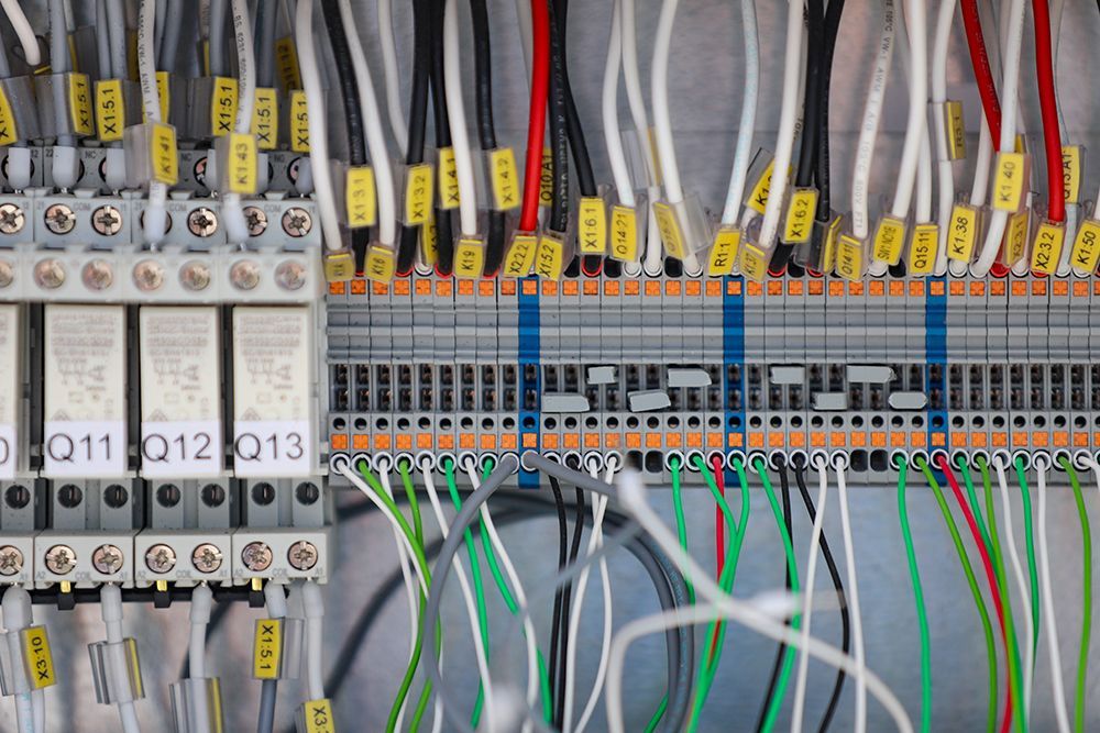 A close up of a electrical panel with lots of wires and connectors.