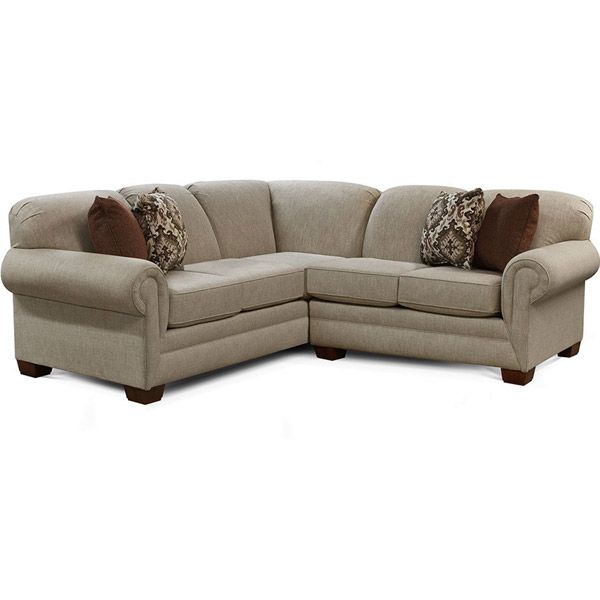 Beige sectional sofa with patterned throw pillows on a white background