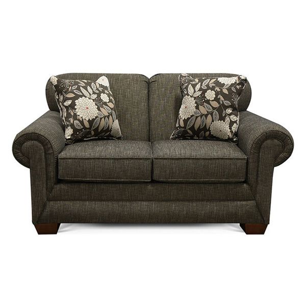 Dark brown loveseat with floral pillows and rolled arms on a white background
