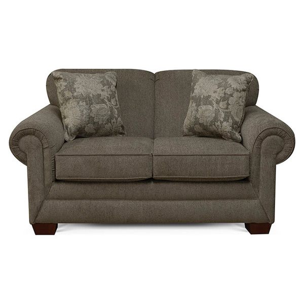 Brown loveseat with rolled arms and two patterned accent pillows