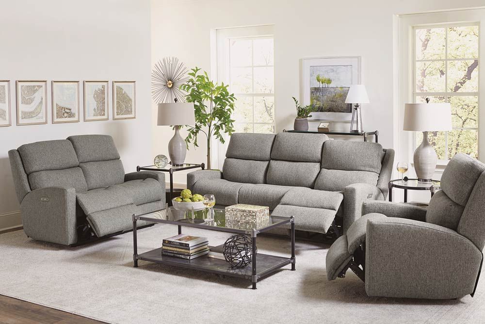 Gray reclining living room set with sofa, loveseat, chairs, coffee table, and framed wall art