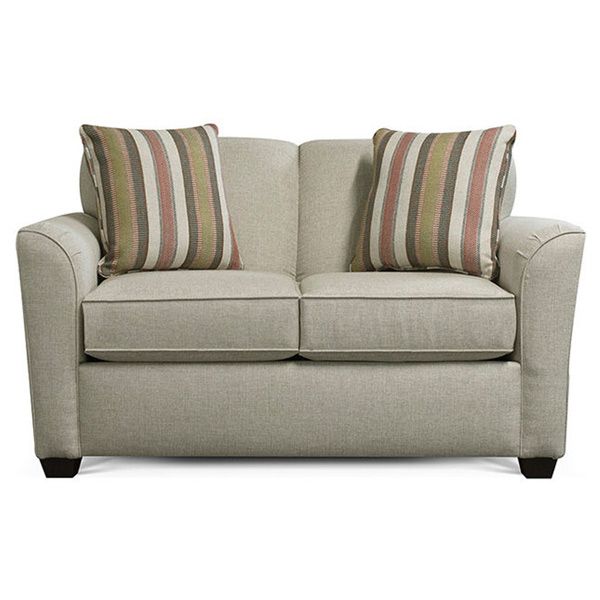Beige loveseat with two striped accent pillows on a white background