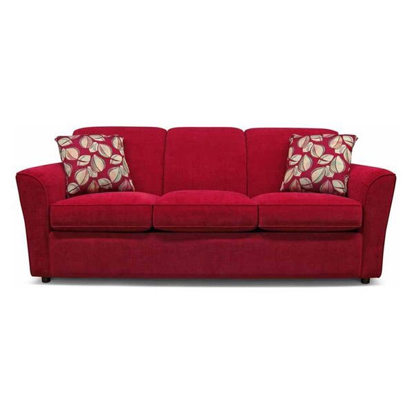 Red sofa with two patterned throw pillows on a white background
