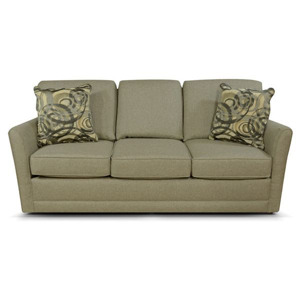Tan upholstered sofa with three seats and two patterned throw pillows