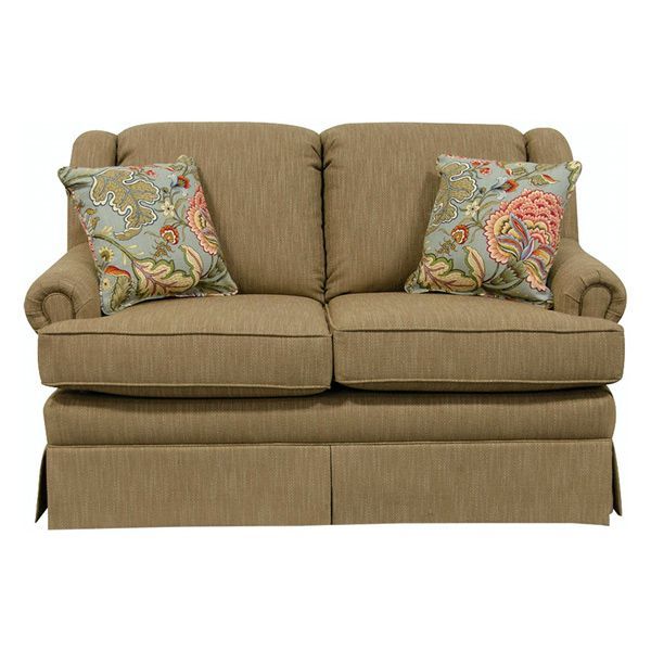 Beige upholstered loveseat with floral throw pillows and skirted base
