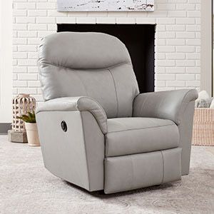 Light gray reclining armchair in front of a white brick fireplace