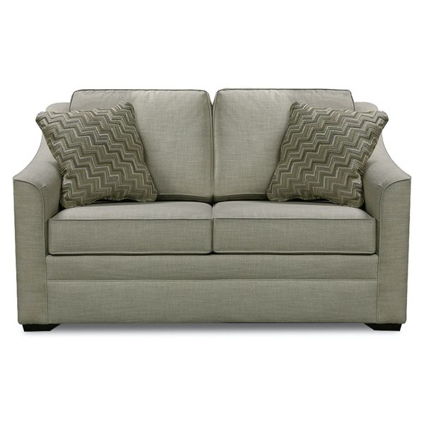 Light gray upholstered loveseat with two patterned throw pillows