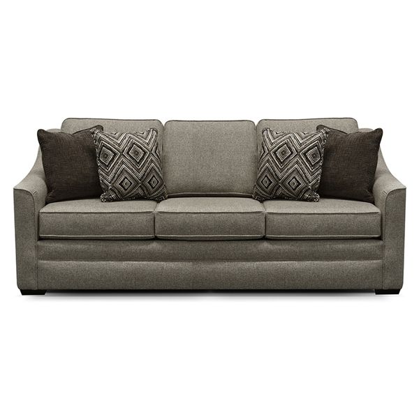 Gray upholstered sofa with two dark patterned accent pillows and two brown pillows