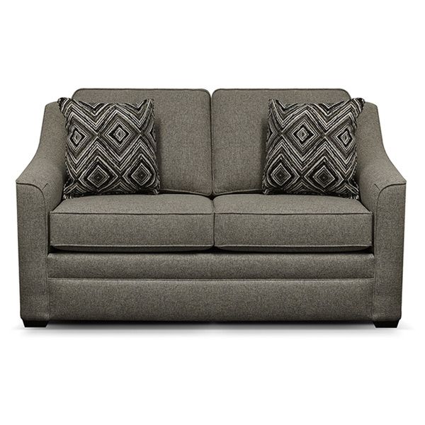 Gray two-seat sofa with patterned throw pillows on a white background