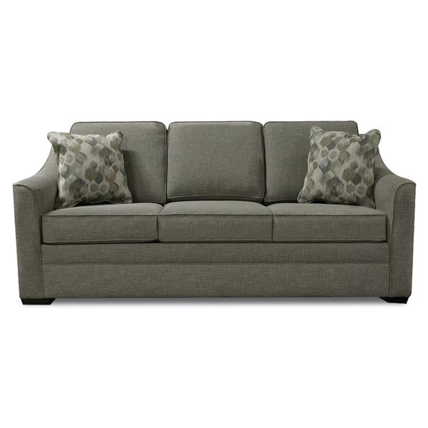 Gray upholstered sofa with three seat cushions and two patterned throw pillows