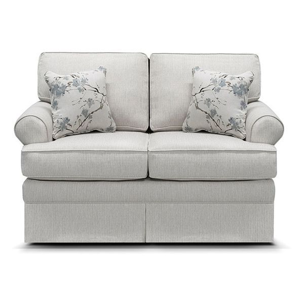 Light gray loveseat with floral throw pillows, upholstered arms, and skirted base on a white background