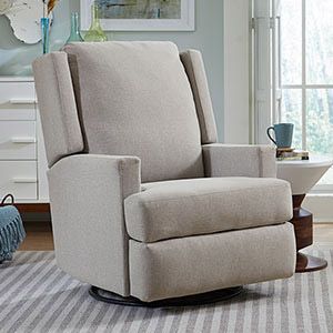 Beige upholstered recliner chair in a bright living room with side table and striped rug
