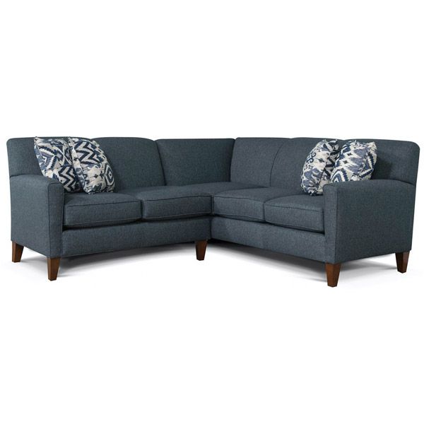 Blue-gray sectional sofa with patterned throw pillows and wooden legs on a white background