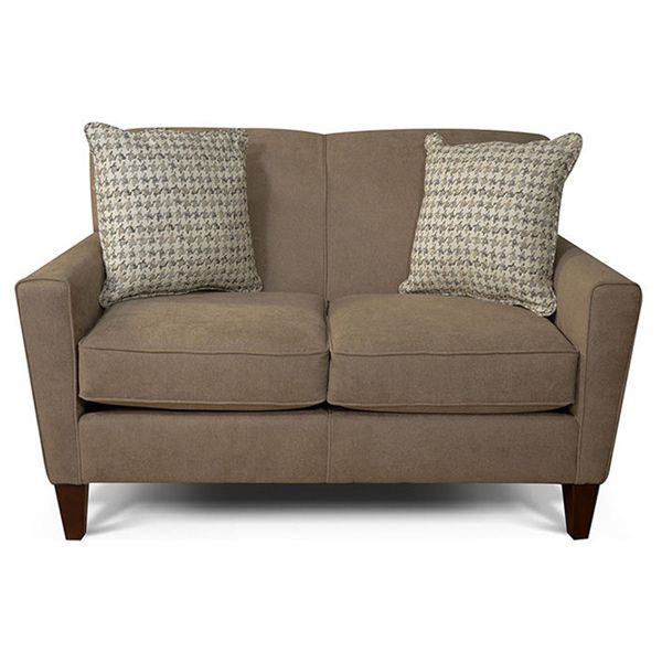 Brown loveseat with two patterned throw pillows on a white background