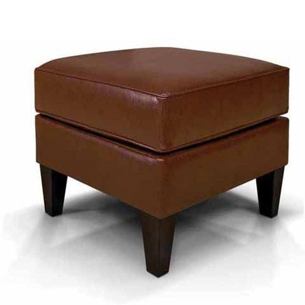 Brown leather ottoman with four dark wooden legs on a white background