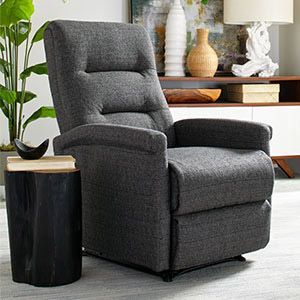 Gray recliner chair beside a black side table in a modern living room