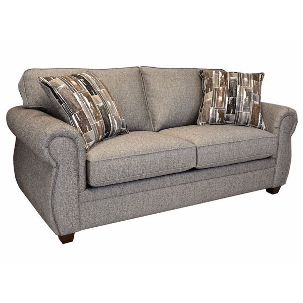 Gray upholstered loveseat with two patterned accent pillows on a white background