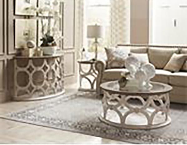 Elegant beige living room with ornate round coffee table, sofa, mirrored cabinet, and patterned rug