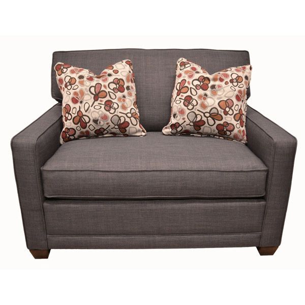 Gray armchair with two patterned throw pillows