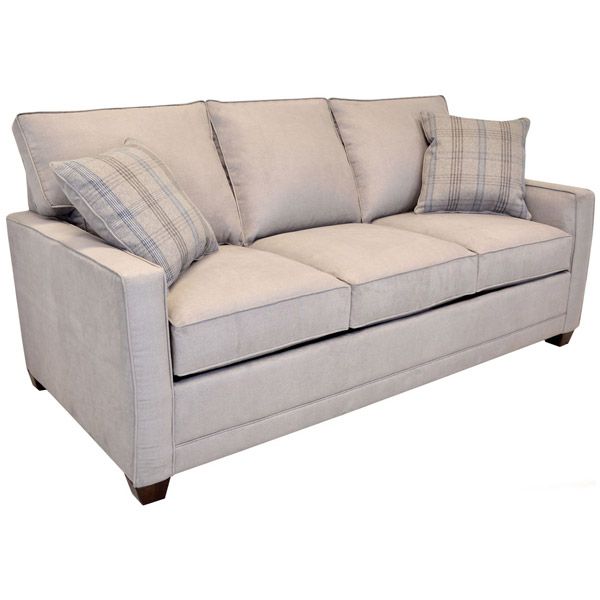Light beige sofa with two plaid accent pillows on a white background