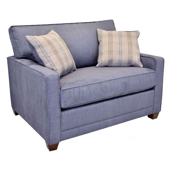 Blue upholstered armchair with two plaid throw pillows and wooden feet