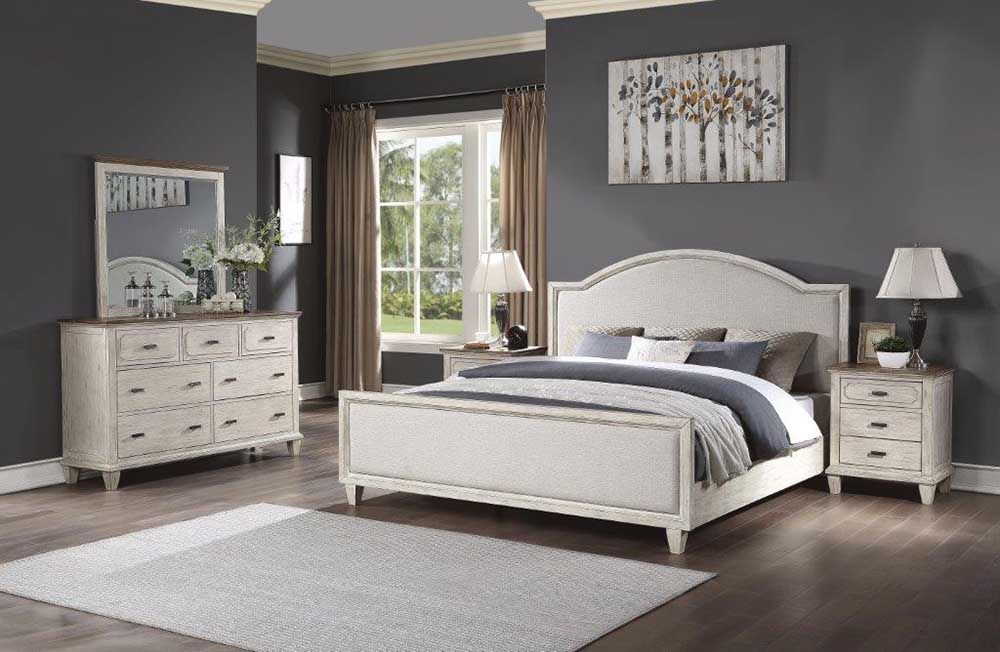Modern bedroom with white bed, dresser, nightstands, mirror, and a window view of greenery