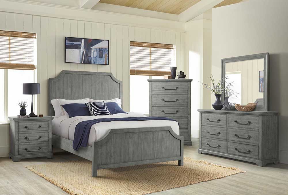 Gray bedroom set with bed, nightstands, dresser, and mirror in a bright room