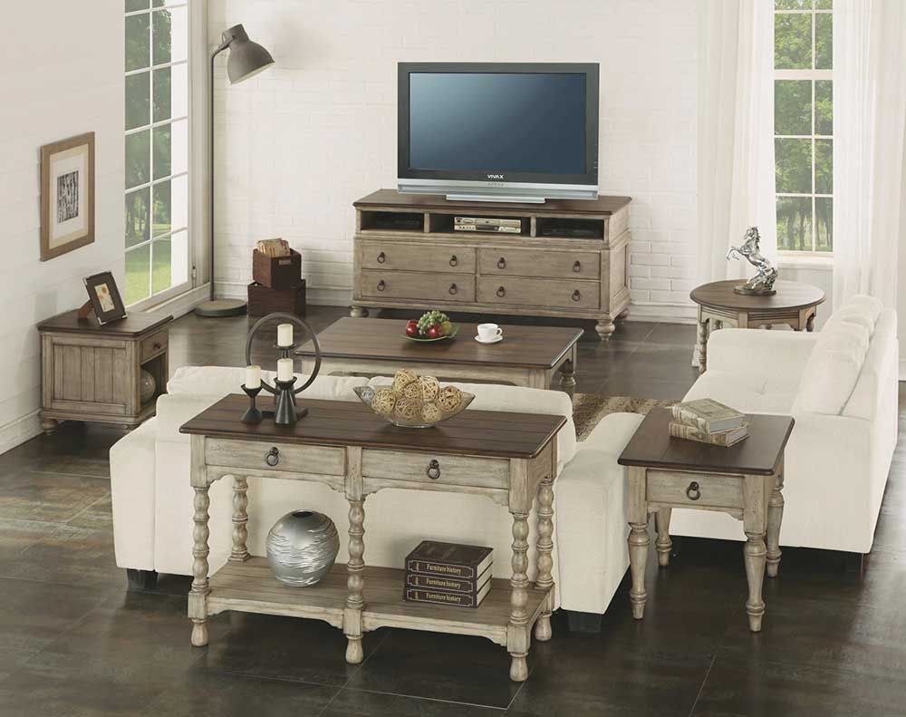 Bright living room with cream furniture, TV console, coffee table, and two armchairs around a sofa