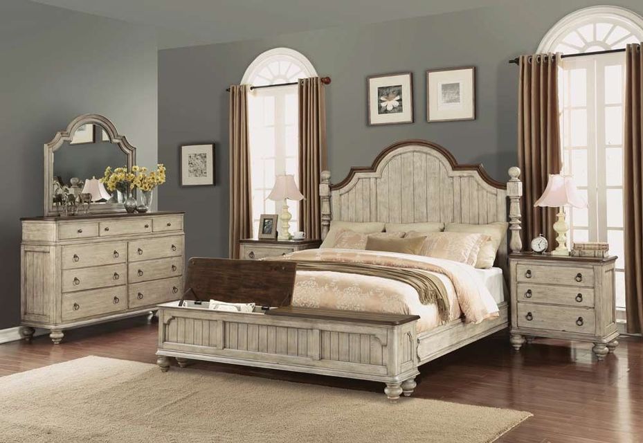 Elegant cream bedroom set with bed, dresser, nightstands, and wall mirrors on gray walls