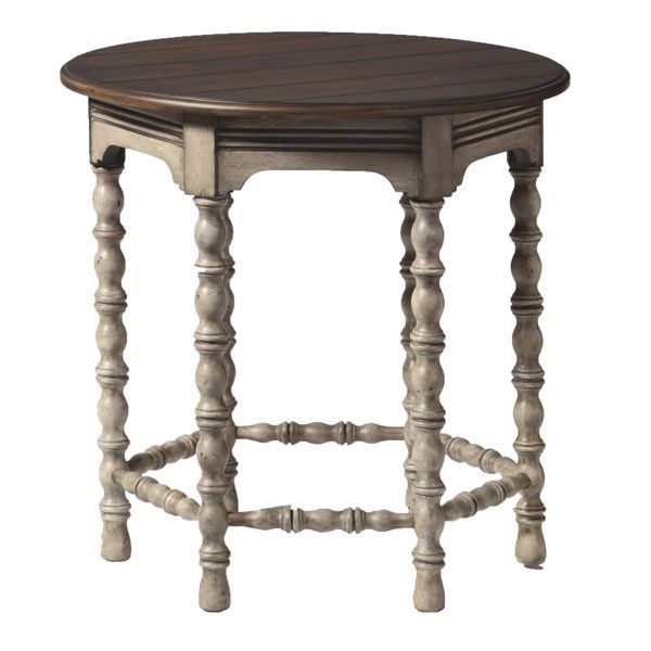 Round wooden side table with ornate carved legs and white lower stretcher