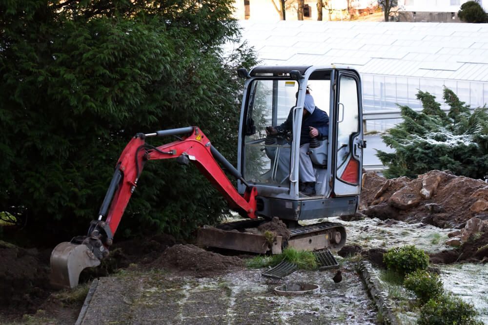 Mini Excavator Digging Trench in Garden — Civil Contractors in Gloucester, NSW