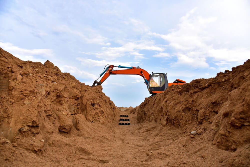 Excavator Digging a Trench — Civil Contractors in Taree, NSW