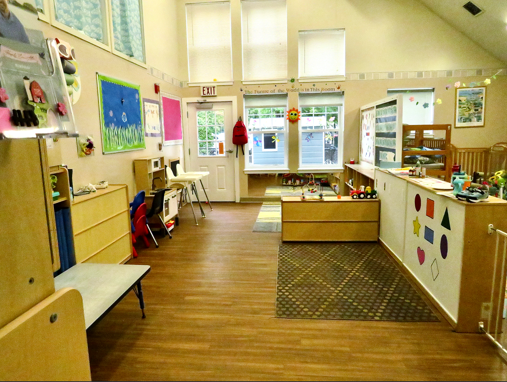 A room with a lot of cribs and high chairs