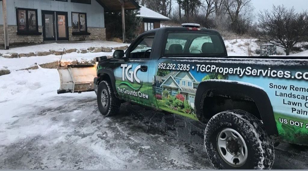 A tgc property services truck is parked in the snow