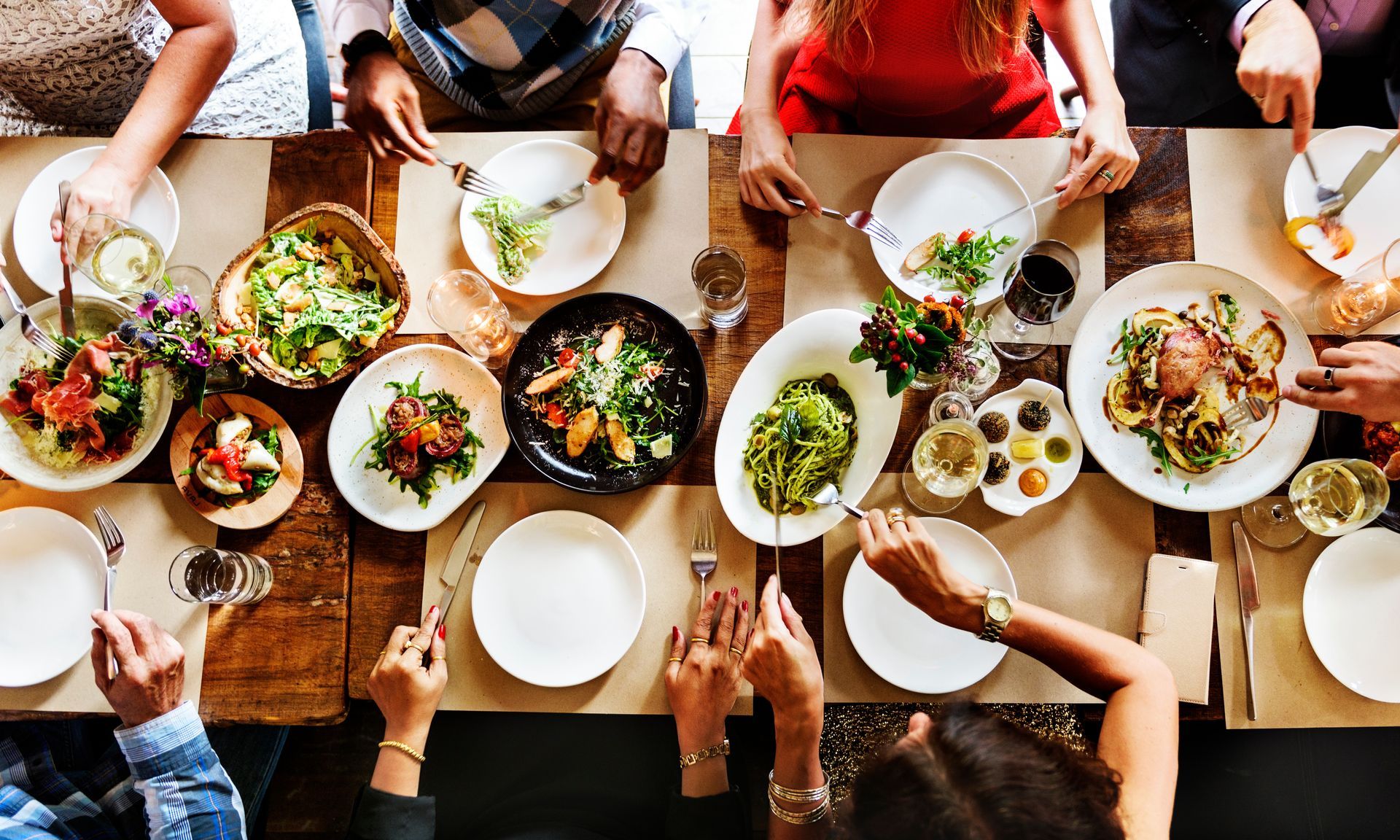 A group of people are sitting at a table eating food.